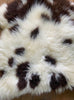 Brown and cream spotty sheepskin rug close up