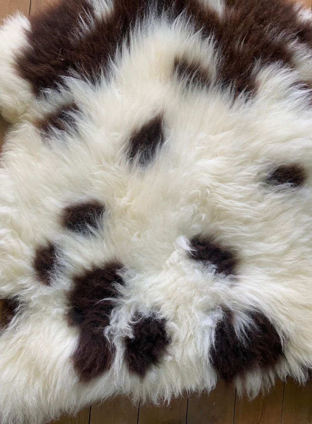 Brown and cream spotty sheepskin rug close up