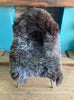 Brown and grey sheepskin rug on chair