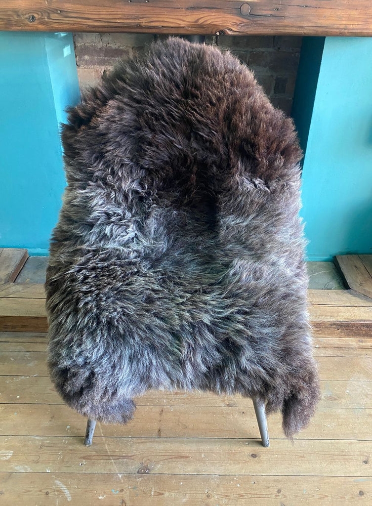Brown and grey sheepskin rug on chair