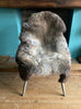 Grey and brown sheepskin rug on chair