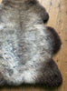 Grey and brown sheepskin rug close up