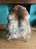 Grey and brown sheepskin rug on chair