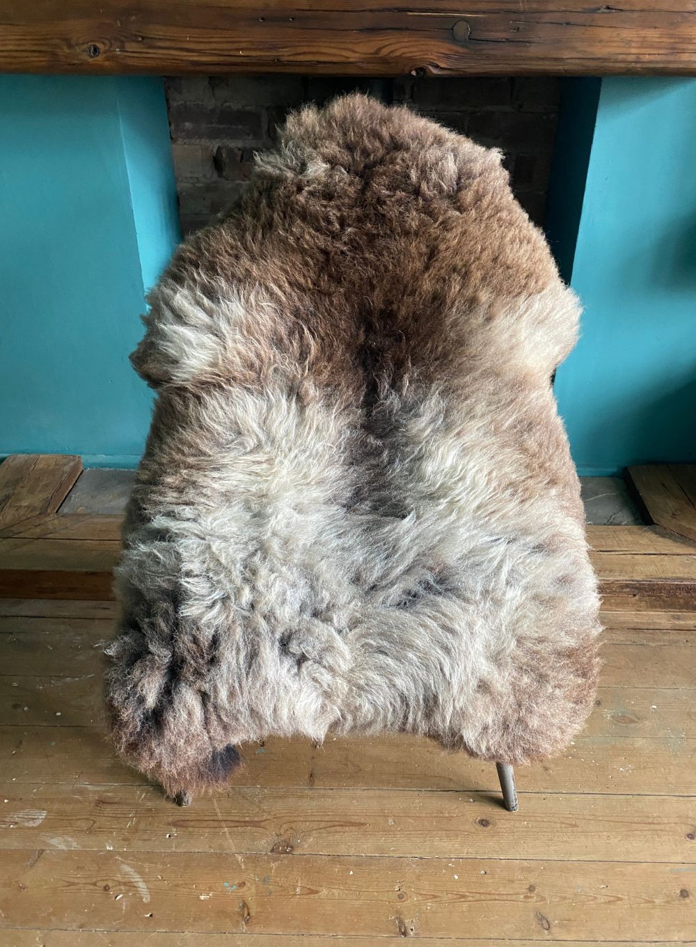 Grey and brown sheepskin rug on chair
