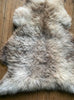 Cream speckled sheepskin rug close up