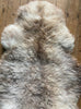 Cream speckled sheepskin rug close up
