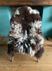 Brown and cream sheepskin rug on chair