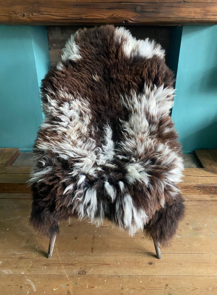Brown and cream sheepskin rug on chair