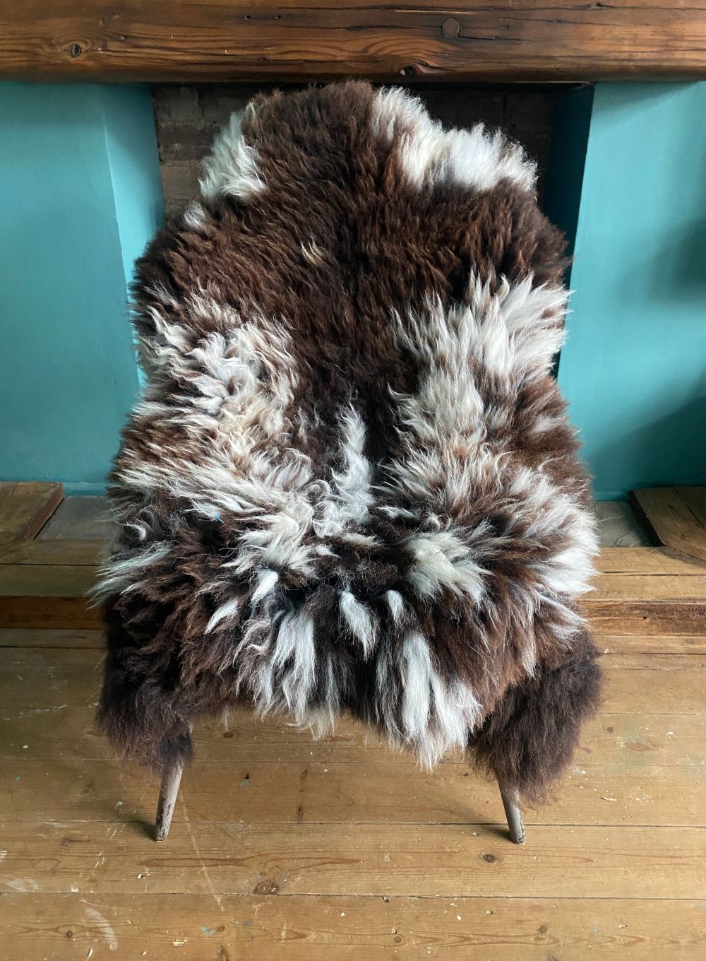 Brown and cream sheepskin rug on chair