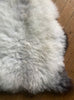 Cream speckled sheepskin rug close up