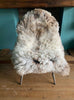 Speckled sheepskin rug on chair