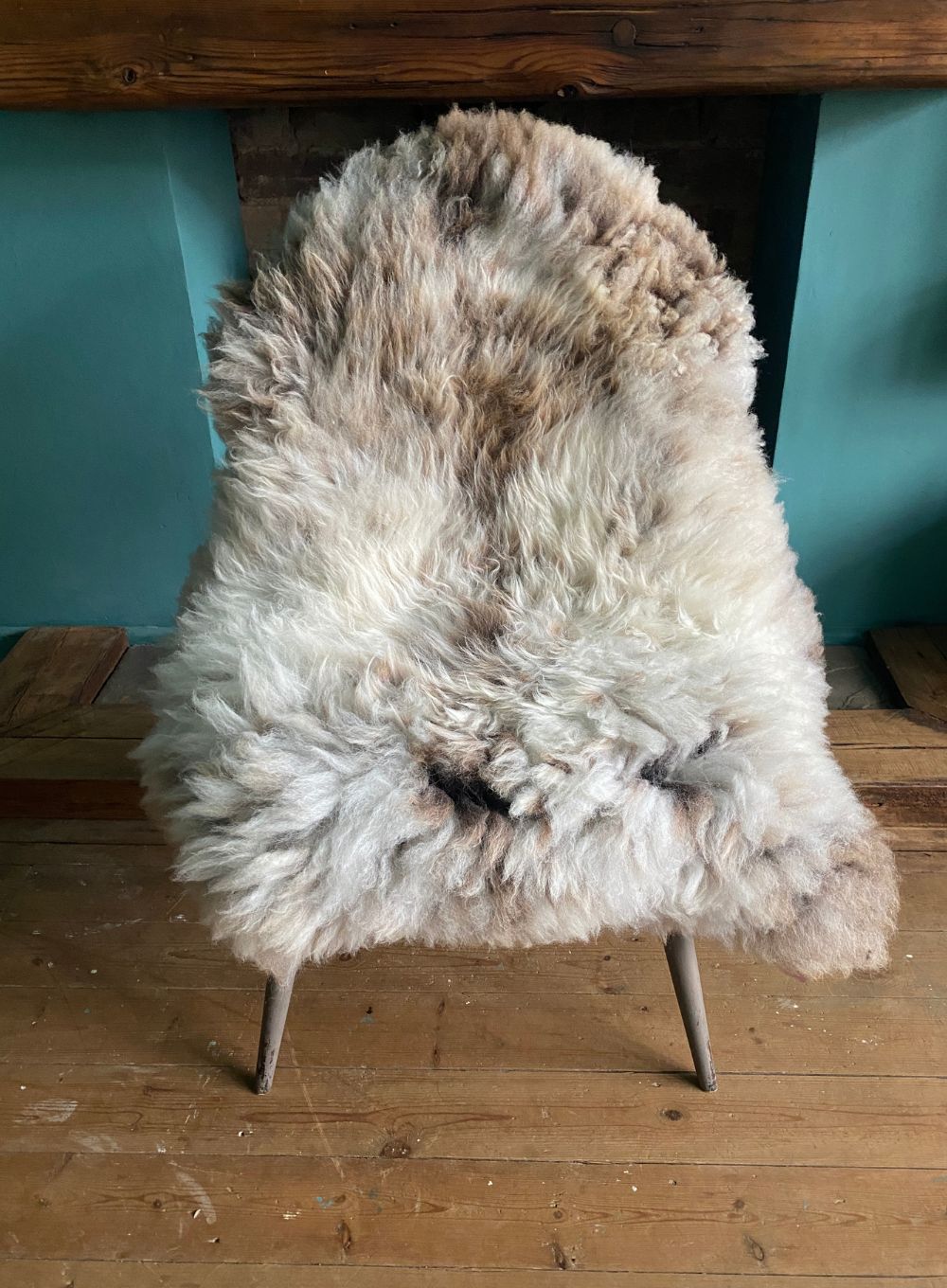 Speckled sheepskin rug on chair