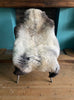 Cream speckled sheepskin rug on chair