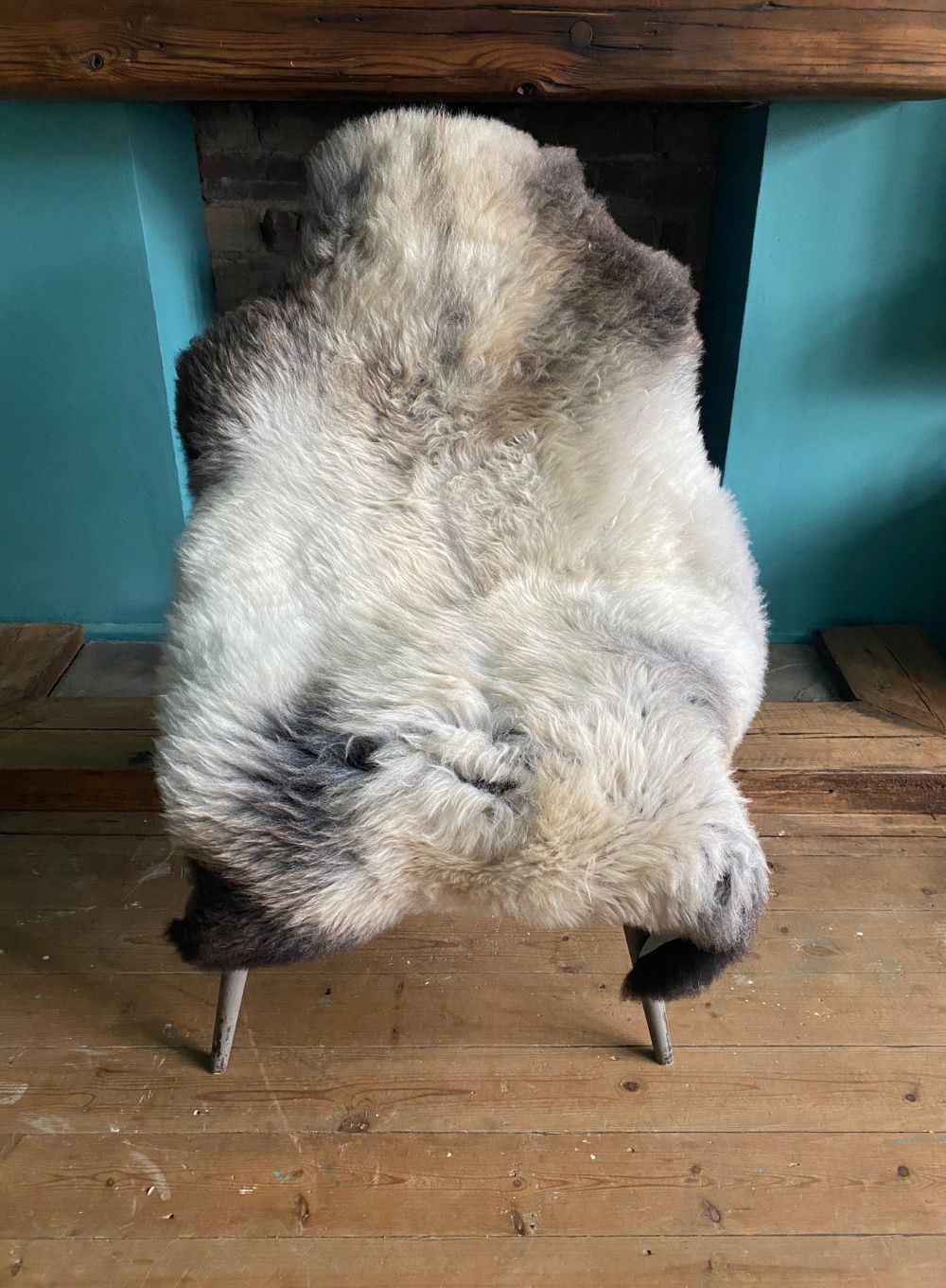 Cream speckled sheepskin rug on chair