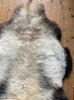 Cream speckled sheepskin rug close up 