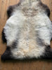 Cream speckled sheepskin rug close up 