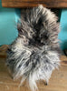 Grey and cream sheepskin rug on chair