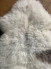 Cream sheepskin rug with brown spot close up