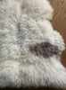 Cream sheepskin rug with brown spot close up