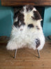 Brown and cream sheepskin rug on chair