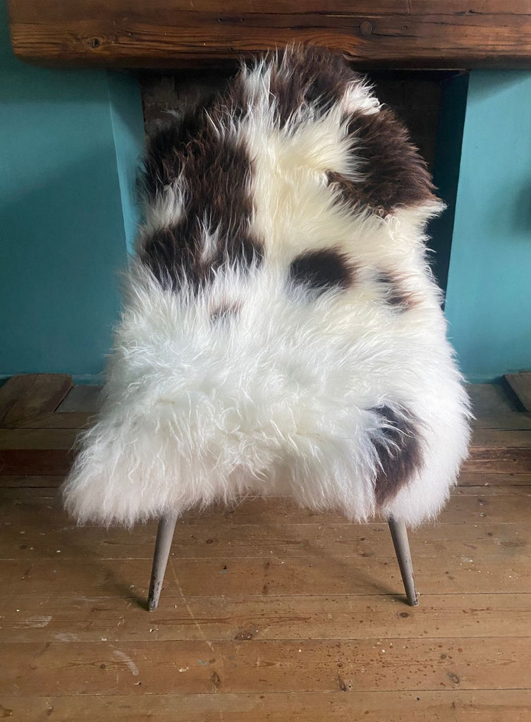Brown and cream sheepskin rug on chair