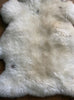 Cream speckled sheepskin rug close up