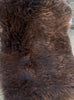 Dark brown sheepskin rug close up