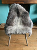 Grey sheepskin rug on chair 