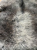Grey sheepskin rug close up