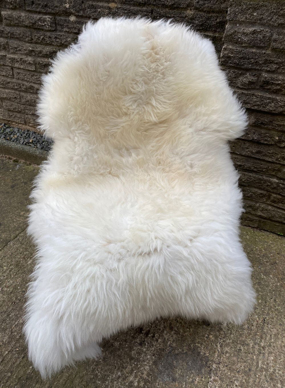 Cream sheepskin rug on chair