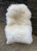 Cream sheepskin rug on chair