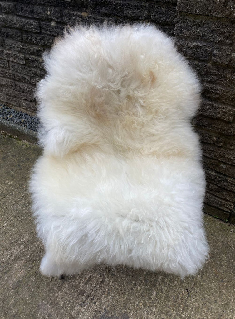 Cream sheepskin rug on chair