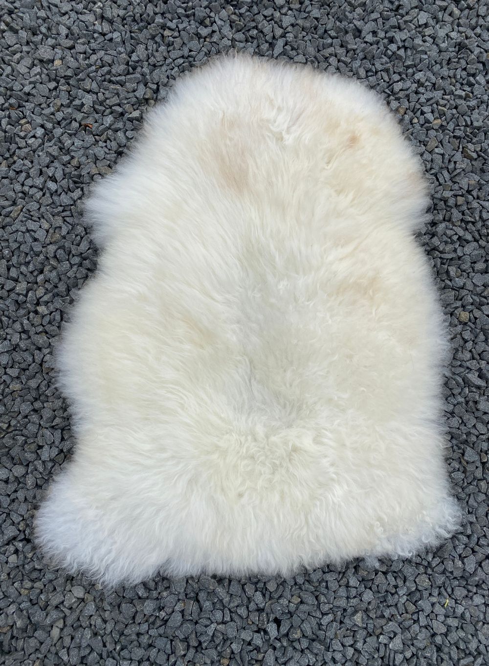 Cream sheepskin rug laid flat
