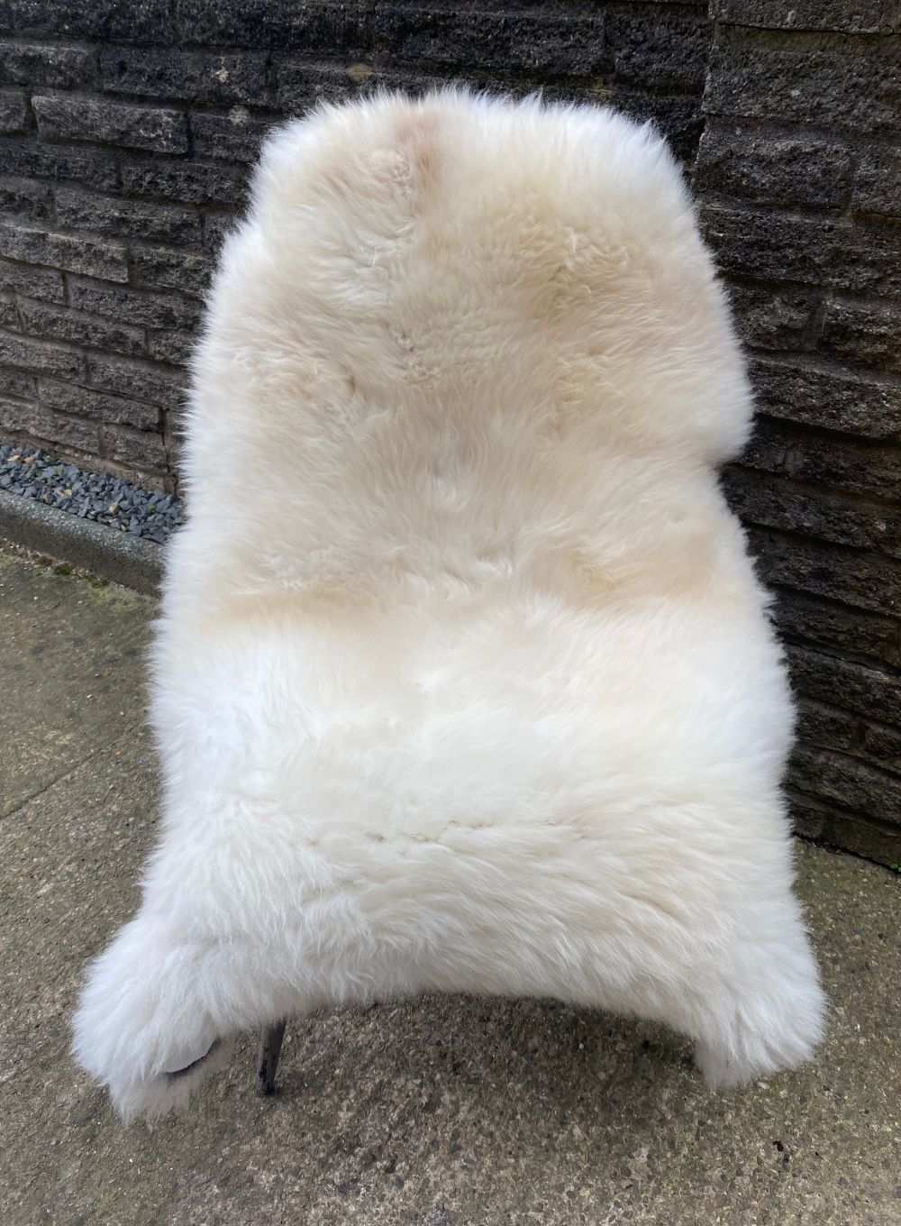 Cream sheepskin rug on chair