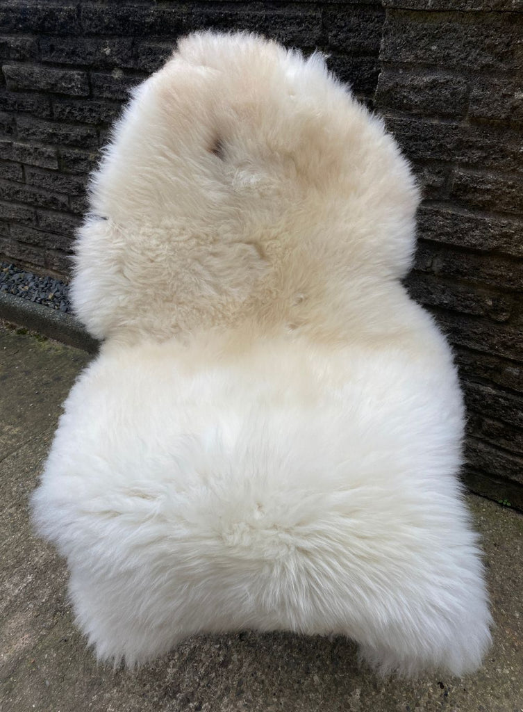 Cream sheepskin rug on chair