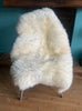 Cream sheepskin rug on chair