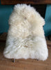 Cream sheepskin rug on chair