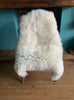 Cream sheepskin rug on chair