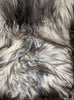 Grey and white sheepskin rug close up