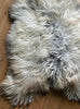 Grey and cream long haired sheepskin rug close up