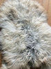 Grey and cream long haired sheepskin rug close up