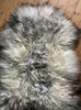 Grey and cream long haired sheepskin rug close up
