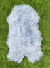 Light silver grey Icelandic sheepskin rug on grass