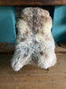 Cream speckled rug on chair