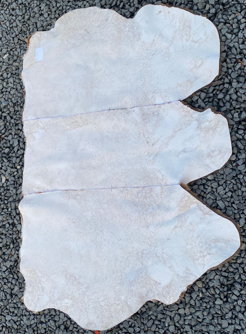 Back of brown short wooled triple sheepskin rug