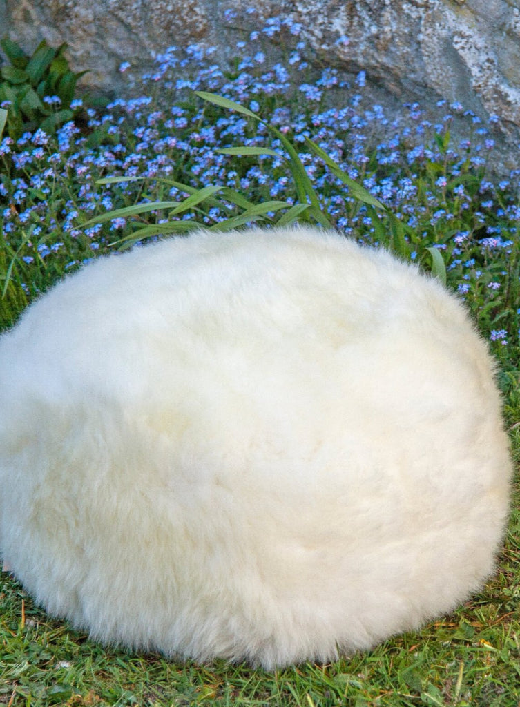 Natural White British Sheepskin Pouffe on grass