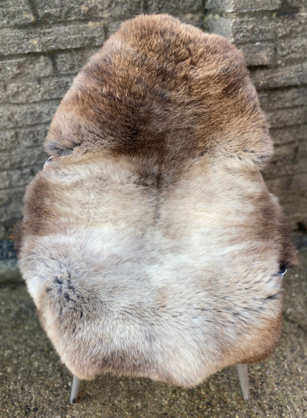 Brown and cream sheepskin rug  on chair