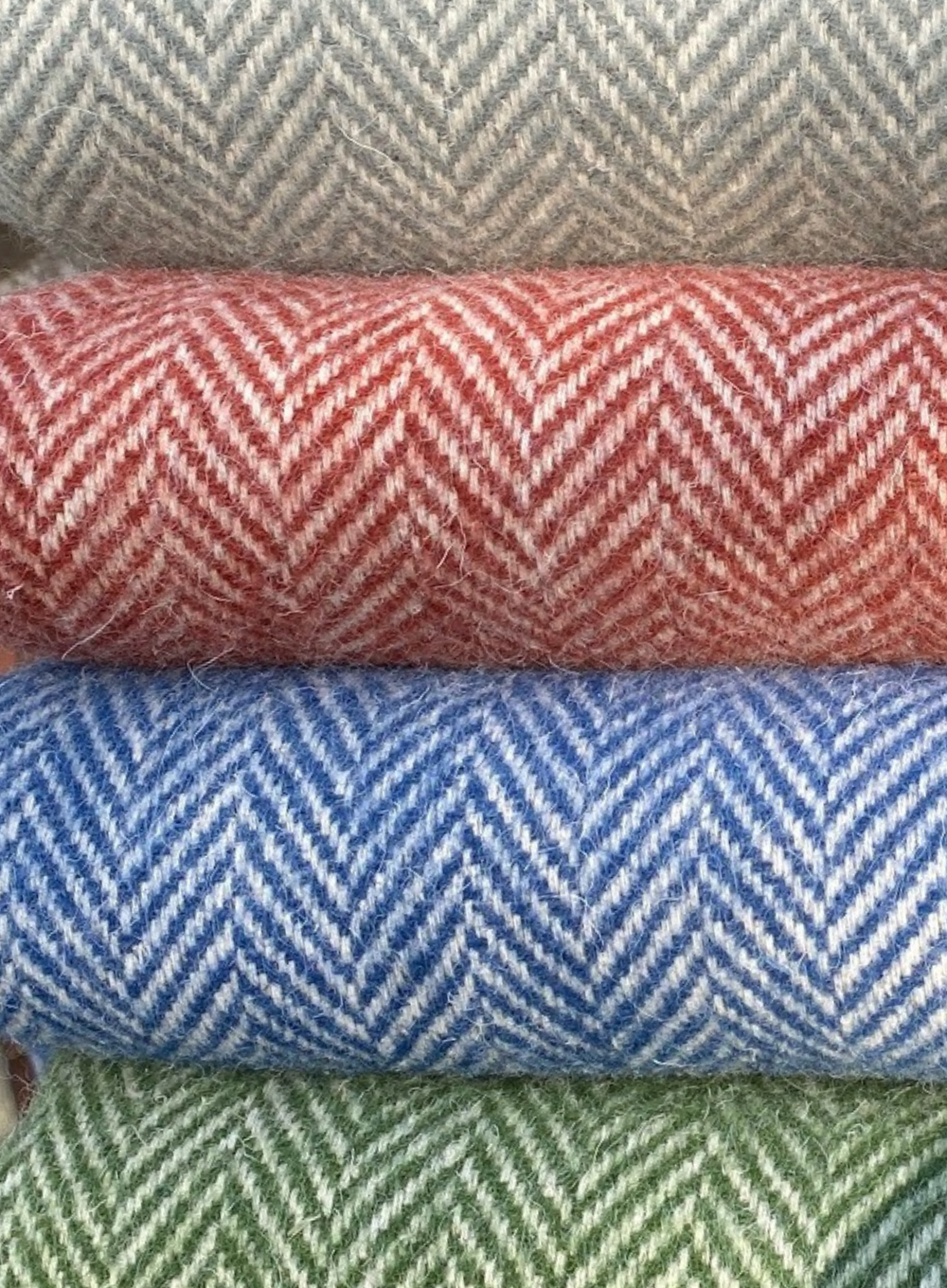 Close up of herringbone throws in four colours 