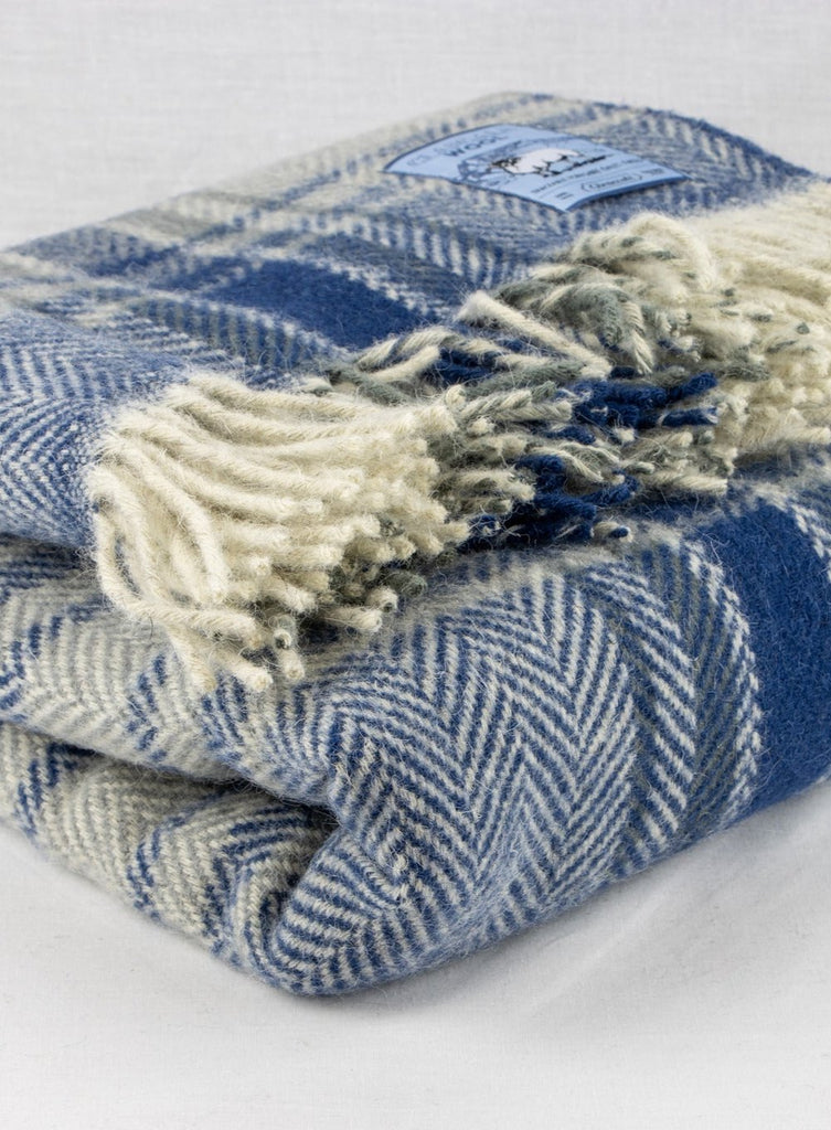 Blue plaid chunky wool travel rug rolled up