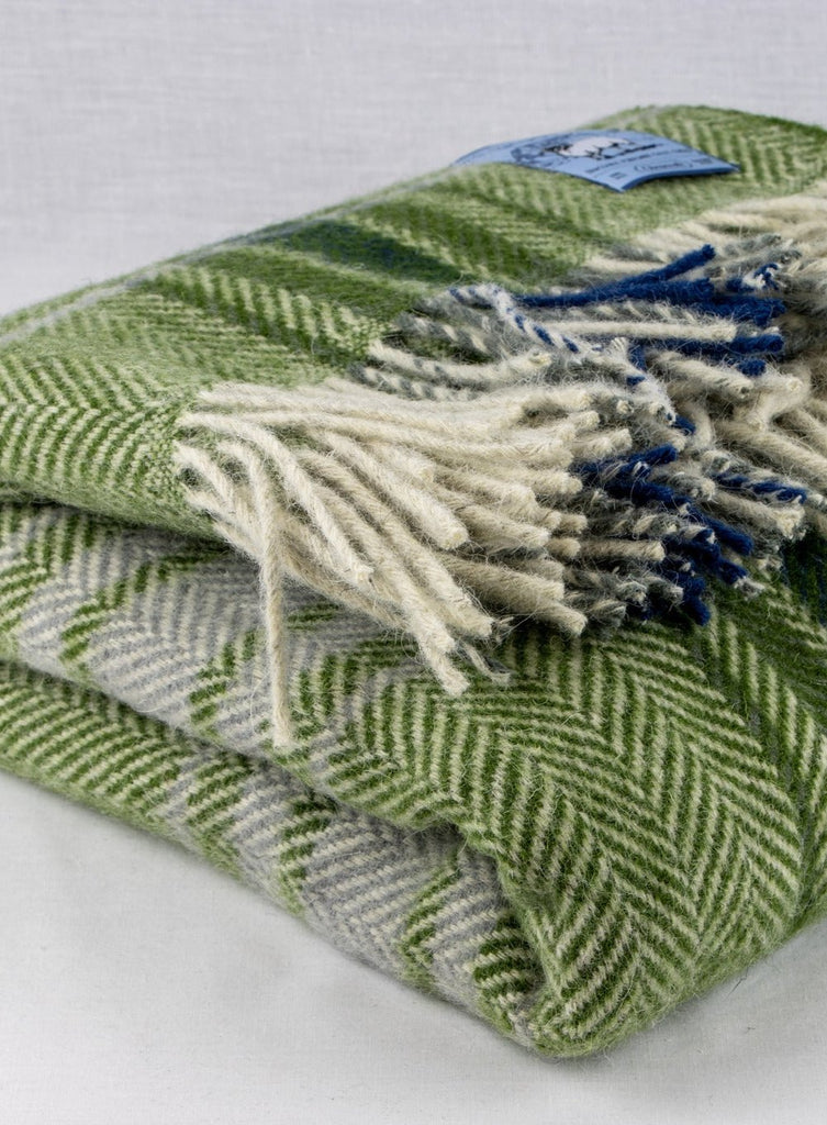 Green plaid chunky wool travel rug rolled up 